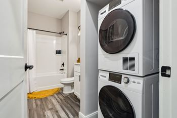 A white washing machine and dryer in a small laundry room.